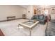 Inviting living room showcasing an ornate glass-top coffee table and wood flooring at 3711 Davis Dr, Charlotte, NC 28270