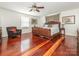Spacious main bedroom showcasing a luxurious bed, hardwood floors, and stylish decor at 3711 Davis Dr, Charlotte, NC 28270