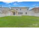 Spacious, fenced backyard with lush green grass and a covered patio area, ideal for relaxing or entertaining guests at 433 Annaberg Ln, Monroe, NC 28110