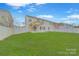 Expansive backyard featuring a well-manicured lawn, privacy fence, and covered patio perfect for outdoor entertaining at 433 Annaberg Ln, Monroe, NC 28110
