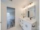 Bright bathroom features white cabinets, dual sinks and mirrors, and modern fixtures at 433 Annaberg Ln, Monroe, NC 28110