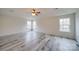 A primary bedroom features a ceiling fan and durable, light gray wood floors at 433 Annaberg Ln, Monroe, NC 28110