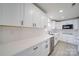 Updated kitchen with white cabinets, quartz countertops, stainless steel appliances, and subway tile at 433 Annaberg Ln, Monroe, NC 28110