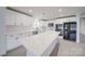 Modern kitchen boasts white cabinets, quartz countertops, stainless appliances, and a center island at 433 Annaberg Ln, Monroe, NC 28110
