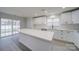 Bright kitchen features white cabinets, subway tile backsplash, stainless appliances, and gray flooring at 433 Annaberg Ln, Monroe, NC 28110