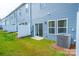 Townhome backyard with blue siding, privacy fence, sliding door, and grassy area at 508 Tayberry Ln, Fort Mill, SC 29715