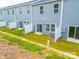 A view of the back of a townhouse and outdoor lawn at 508 Tayberry Ln, Fort Mill, SC 29715
