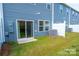 Townhome backyard featuring blue siding, sliding door, and a grassy area at 508 Tayberry Ln, Fort Mill, SC 29715