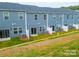 Row of townhomes with blue siding, backyard patios, and grassy landscaping at 508 Tayberry Ln, Fort Mill, SC 29715