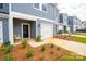 Close up of townhome featuring a one car garage, neutral exterior, and neatly maintained flowerbeds at 508 Tayberry Ln, Fort Mill, SC 29715