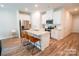 Open kitchen features an island with bar stool seating, stainless appliances, and white cabinetry at 508 Tayberry Ln, Fort Mill, SC 29715
