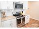 Kitchen features stainless appliances, subway tile backsplash, white cabinetry, and sleek countertops at 508 Tayberry Ln, Fort Mill, SC 29715
