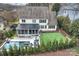An aerial shot reveals the backyard's pool, putting green, screened-in porch, landscaping, and patio at 5231 Lila Wood Cir, Charlotte, NC 28209