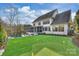 Expansive backyard features a putting green, lush lawn, and white brick home exterior at 5231 Lila Wood Cir, Charlotte, NC 28209