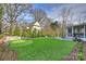 Beautiful backyard with a well-manicured lawn, putting green, pool, and exterior of home at 5231 Lila Wood Cir, Charlotte, NC 28209
