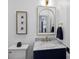 Elegant bathroom featuring marble countertops, gold fixtures, and decorative artwork at 5231 Lila Wood Cir, Charlotte, NC 28209
