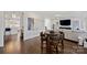 Charming dining area with a round table, leather chairs, and a view of the living room at 5231 Lila Wood Cir, Charlotte, NC 28209