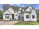 Charming two-story brick home featuring a manicured front yard and attached two-car garage at 5231 Lila Wood Cir, Charlotte, NC 28209