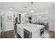Bright kitchen featuring a large white island, stainless steel appliances, gold fixtures, and eat-in bar seating at 5231 Lila Wood Cir, Charlotte, NC 28209