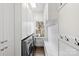 Bright laundry room equipped with modern washer/dryer and ample storage cabinets at 5231 Lila Wood Cir, Charlotte, NC 28209