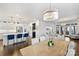 Open-concept living room with hardwood floors, modern lighting, kitchen island, and access to the outdoor space at 5231 Lila Wood Cir, Charlotte, NC 28209