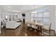 Bright, open living room featuring hardwood floors, fireplace, modern lighting, and lots of natural light at 5231 Lila Wood Cir, Charlotte, NC 28209