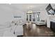 Cozy living room with hardwood floors, a fireplace, access to outdoor space, and comfortable, neutral-toned furniture at 5231 Lila Wood Cir, Charlotte, NC 28209