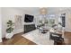 Bright living room with large windows, hardwood floors, and a comfortable sectional sofa at 5231 Lila Wood Cir, Charlotte, NC 28209