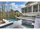Lush backyard featuring a modern pool, spa and outdoor living space at 5231 Lila Wood Cir, Charlotte, NC 28209