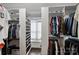 Spacious walk-in closet with custom shelving, hanging rods and a window for natural light at 5231 Lila Wood Cir, Charlotte, NC 28209