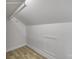 Unfinished attic space with updated floor and clean white walls at 56 Linneys Mountain Rd, Taylorsville, NC 28681