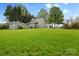 Expansive backyard featuring a well-maintained lawn, detached garage, and a charming gazebo at 56 Linneys Mountain Rd, Taylorsville, NC 28681