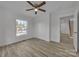 Bright bedroom with a ceiling fan and closet, showcasing the vinyl floors and natural light at 56 Linneys Mountain Rd, Taylorsville, NC 28681