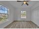 Bright bedroom featuring two windows and a ceiling fan, creating an airy and comfortable space at 56 Linneys Mountain Rd, Taylorsville, NC 28681