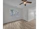 Bedroom featuring light-filled windows, modern flooring, and a ceiling fan at 56 Linneys Mountain Rd, Taylorsville, NC 28681