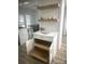 Butler pantry features white cabinetry, quartz countertops, floating shelves, and convenient storage solutions at 56 Linneys Mountain Rd, Taylorsville, NC 28681