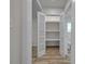 Spacious closet with ample shelving space, open doors and hardwood floors at 56 Linneys Mountain Rd, Taylorsville, NC 28681