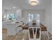 Bright dining area featuring a wood table, white chairs, and natural light from the large window at 56 Linneys Mountain Rd, Taylorsville, NC 28681