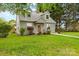Charming home with dormer windows, a shake siding exterior, and a walkway leading to the front door at 56 Linneys Mountain Rd, Taylorsville, NC 28681