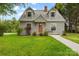 Charming two-story home featuring dormer windows, well-maintained lawn, and welcoming front entrance at 56 Linneys Mountain Rd, Taylorsville, NC 28681