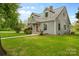 Charming home with dormer windows, shake siding, and a front walkway lined with landscaping at 56 Linneys Mountain Rd, Taylorsville, NC 28681