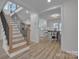 Bright foyer featuring staircase and views into the dining and kitchen areas at 56 Linneys Mountain Rd, Taylorsville, NC 28681