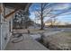 Inviting front porch featuring seating area overlooking the landscaped yard, perfect for relaxing outdoors at 56 Linneys Mountain Rd, Taylorsville, NC 28681