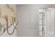 Hallway with coat hooks leading to closet and bathroom with hardwood floors at 56 Linneys Mountain Rd, Taylorsville, NC 28681