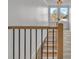 A hallway and staircase featuring wood and metal railings with an outdoor view at 56 Linneys Mountain Rd, Taylorsville, NC 28681