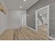 Hallway with bench, hardwood floors, gray accent wall and staircase at 56 Linneys Mountain Rd, Taylorsville, NC 28681