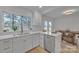 Bright kitchen with updated cabinetry, stainless steel dishwasher, and view to dining area at 56 Linneys Mountain Rd, Taylorsville, NC 28681