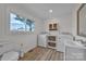 Well-lit laundry room with modern washer, dryer, built-in cabinetry, sink, and stylish flooring at 56 Linneys Mountain Rd, Taylorsville, NC 28681