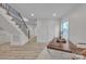 Bright office space with modern desk, hardwood floors, staircase, and natural light from the large window at 56 Linneys Mountain Rd, Taylorsville, NC 28681