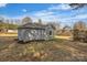A detached outbuilding with concrete wall and gray siding, set on a grassy lawn at 56 Linneys Mountain Rd, Taylorsville, NC 28681